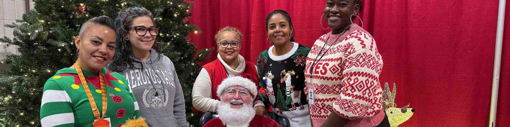 Tommy Toy volunteers with Santa