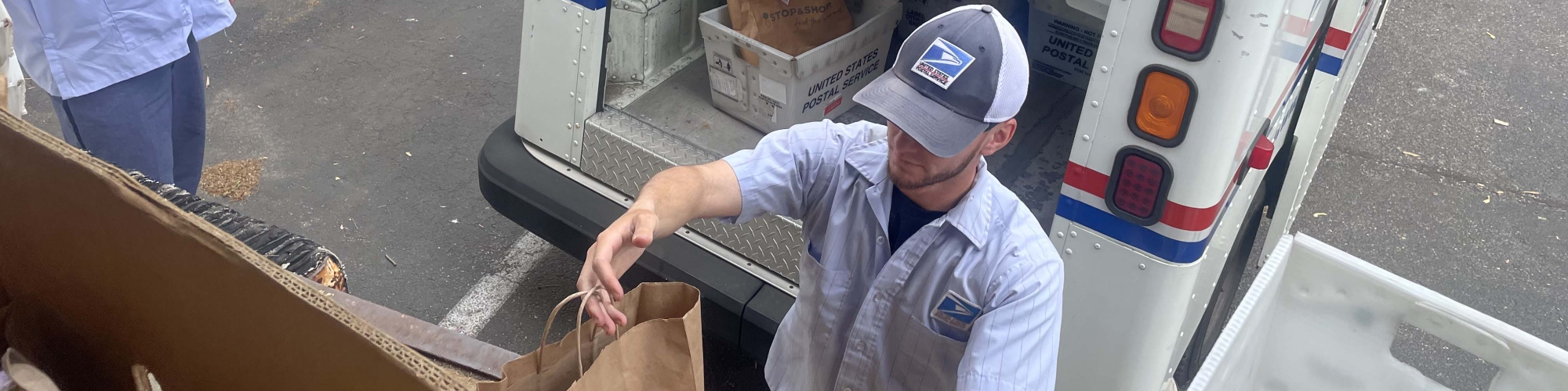 Letter carriers delivering food donations to the Food Center