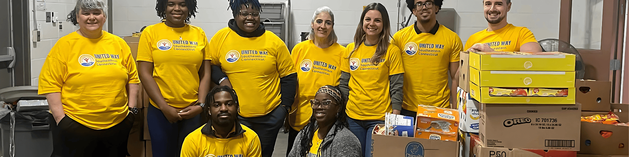 A group of volunteers posing after volunteering at the Food Center warehouse