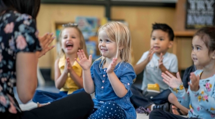 children at daycare clapping hands