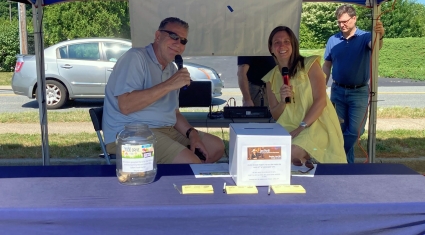 WCTY radio at their table broadcasting from last year's summer food drive